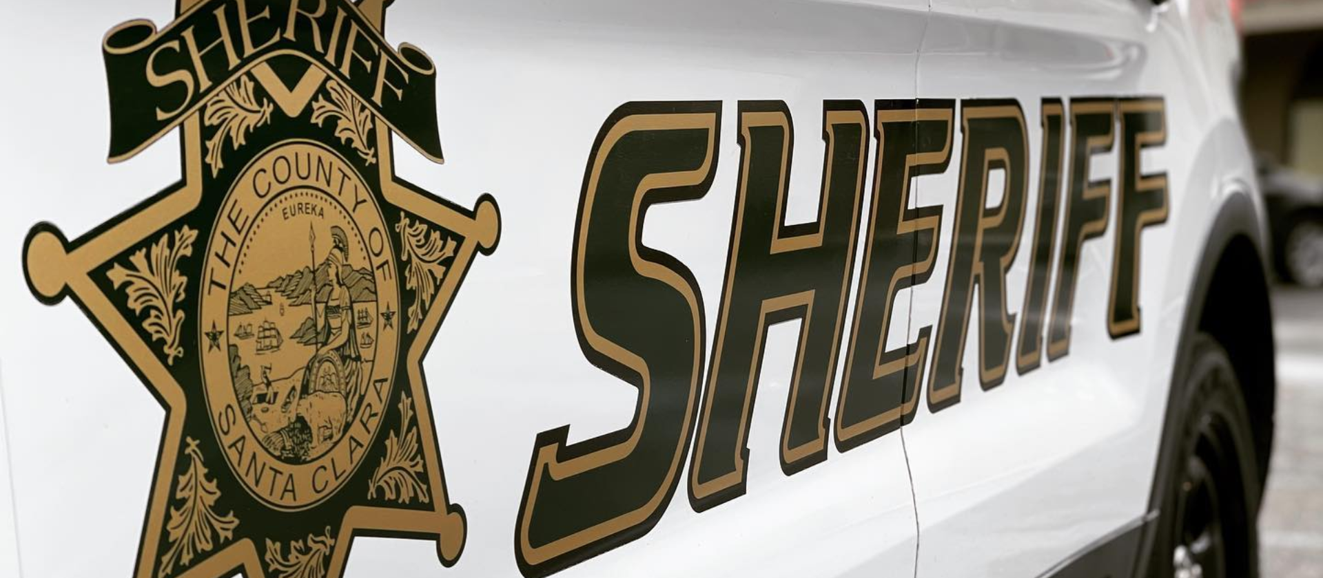 Side of sheriff car that reads The County of Santa Clara SHERIFF